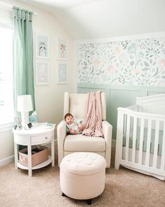 a baby sitting in a chair next to a white crib