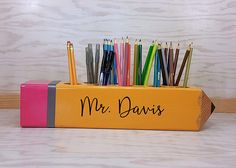 the pencils are lined up in a box with writing on it, which says mr davis