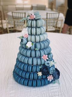 a cake made out of macaroni and cheese on a table with chairs in the background