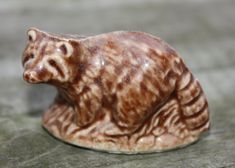 a small ceramic cat sitting on top of a wooden table