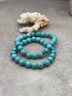 Step into a world of serene beauty with our Elegant Turquoise Stretch Bracelet. This exquisite piece is carefully handcrafted, featuring genuine turquoise beads in a mesmerizing shade of blue that evokes the tranquility of the sea and the vastness of the sky. Each bead is a testament to the timeless allure of turquoise, a stone cherished through centuries for its unique hue and spiritual significance. Turquoise 8mm Sterling Silver spacers Turquoise Amazonite Round Bracelets, Handmade Turquoise Amazonite Bracelets, Handmade Turquoise Round Beaded Bracelets, Handmade Round Turquoise Beaded Bracelets, Handmade Turquoise Stretch Bracelet For Healing, Adjustable Howlite Bracelet With 8mm Beads, Hypoallergenic Turquoise Stretch Bracelet Gift, Turquoise Beaded Healing Bracelets, Turquoise Gemstone Beads Stretch Bracelet As Gift