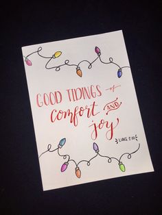 a piece of paper with string lights on it that says good tidings and comfort and joy