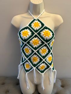 Bohemian hand made crocheted top.  One size fits most. Handmade Fitted Crochet Top For Beach, Hippie Beach Tops With Crochet Trim, Spring Bohemian Crochet Top With Granny Square, Bohemian Crochet Trim Halter Top For Festival, Bohemian Crochet Top With Granny Square For Spring, Summer Crochet Lace Top Made Of Yarn, Bohemian Granny Square Crochet Top For Beach, Bohemian Crochet Lace Halter Top For Summer, Bohemian Granny Square Crochet Top For Spring