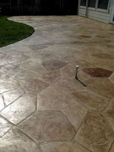 an outdoor patio with stone pavers and grass