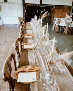 a long table is set up with place settings and napkins for guests to sit at