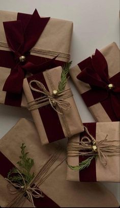 three wrapped presents tied with twine and ribbons