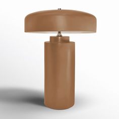 a brown table lamp sitting on top of a white floor