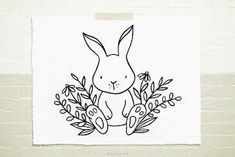 a black and white drawing of a rabbit surrounded by flowers on a piece of paper