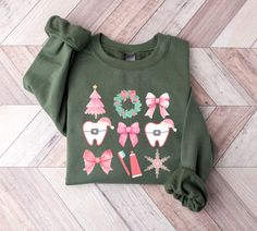 Cute Orthodontist Pink Christmas Themed T-shirt for Orthodontic Staff Solid Colors: 100% Cotton Heather Colors: 80% Cotton, 20% Polyester >> Please check size charts before ordering! PRODUCT DETAILS       * Our products are unisex       * If you would like a tighter fit, please order one size down for shirts. For Comfort Colors, order 2 sizes up for T-shirt Dress.       * For Gildan Sweatshirts and Hoodies, sizing runs true to fit. Order up for oversized look.      * Follow care instructions Ortho Office, Dental Christmas, Dental Shirts, Christmas Crewneck Sweatshirt, Group Matching, Tech T Shirts, Christmas Crewneck, Sweatshirts And Hoodies, Gildan Sweatshirts