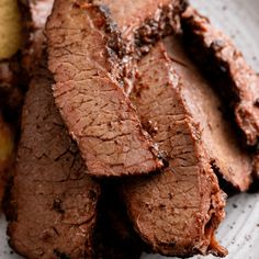 some meat is sitting on a plate with potatoes