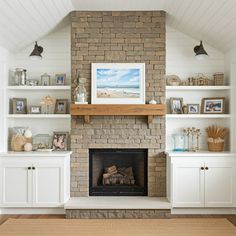 a living room with a fire place and shelves on either side of the fireplace that is built into the wall