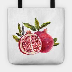 a watercolor painting of two pomegranates on a white tote bag