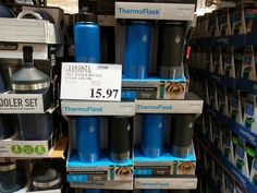 thermos are stacked on top of each other for sale in a store aisle