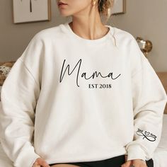 Personalized Mama Sweatshirt, Mama Est Crewneck Sweatshirt, Unisex Sweatshirt, Womens Fall Winter Sweatshirt, Kids Names Sleeve Sweatshirt by WINDINGTRAILDESIGNCo on Etsy Personalized Clothing, Kids Names, Mama Sweatshirt, Winter Sweatshirt, Infinity Symbol, Personalized Clothes, Womens Fall, Kid Names, Unisex Sweatshirt