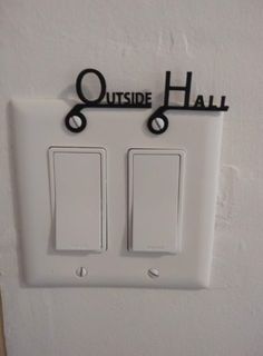 two light switch plates with the words outside hall written on one side and an upside down sign above them