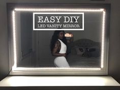 a woman standing in front of a mirror with the words easy diy led vanity mirror