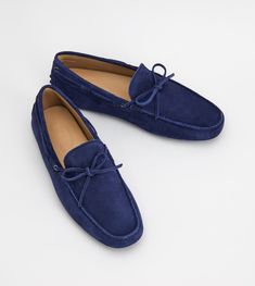 Tod's Gommino driving shoes in velvet suede with exposed hand stitching, hot-stamped monogram, front tie and iconic rubber pebble outsole. A timeless design available in a wide range of colors. Elegant Suede Boat Shoes With Leather Sole, Formal Suede Boat Shoes With Stitched Sole, Classic Suede Boat Shoes With Stitched Sole, Luxury Italian Suede Loafers, Driving Moccasins With Leather Sole And Suede Material, Luxury Suede Driving Loafers, Elegant Branding, Moccasins Shoes, Driving Loafers