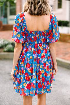 This dress is what dreams are made of! That floral print is so cute and are loving those bold colors! That babydoll fit is also really light and flowy for the summer! You are going to love styling this cutie with heels, sandals, or sneakers! This dress features a square neckline, short puff sleeves, a babydoll fit, and a floral print. Material has no amount of stretch.Cam is wearing the small. Cute Flowy Floral Dress, Playful Floral Print Dress For Vacation, Playful Floral Print Vacation Dresses, Light Blue Floral Dress For Summer, Cute Flowy Floral Summer Dress, Cute Flowy Floral Dress For Summer, Fun Floral Print Vacation Dress, Blue Ditsy Floral Print Dress For The Beach, Light Blue Summer Floral Dress For Vacation