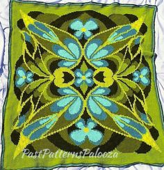 a green pillow with blue flowers on it