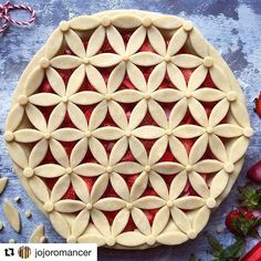 a close up of a pie on a table with strawberries and other food items