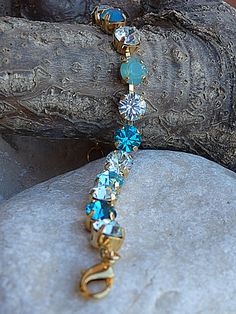 Blue tennis bracelet. Light blue rhinestone elegant Bracelet. Adjustable crystal bracelet for bridesmaid gift. Bridal jewelry gift A beautiful blue swarovski gemstone tennis bracelet. It would be a great wedding accessory for bride, mother of bride, mother of groom and bridesmaids. Metal: 24K Gold Plated Brass or Silver - Nickel free Gemstone: Crystal 8 mm Size: 17 cm long (about 6.8 inches) and has an extension chain to fit all sizes. The bracelet will be packed in a gift box. FOR MATCHING NECK Blue Crystal Bracelets For Wedding, Blue Jeweled Bracelets For Wedding, Blue Jeweled Wedding Bracelets, Blue Tennis Bracelet For Wedding, Groom And Bridesmaids, Wedding Accessories For Bride, Mother Of Groom, Wedding Accessory, Elegant Bracelet