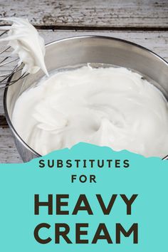 a metal bowl filled with cream next to a whisk on top of a wooden table