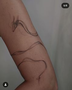 a woman's arm with a tattoo on it that looks like a long snake