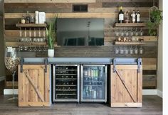 a bar with sliding doors and wine glasses on the top shelf is decorated with wood planks