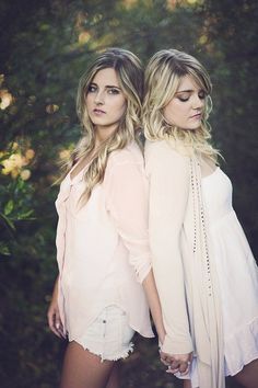 two beautiful young women standing next to each other