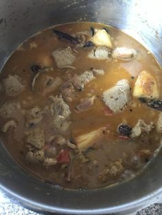 a pot filled with soup sitting on top of a stove