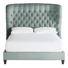 an upholstered bed with white linens and pillows on the headboard, against a white background