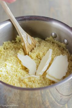 an egg being added to some rice in a pot