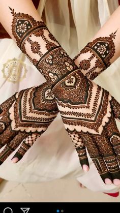 two hands with henna designs on them