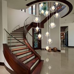 a spiral staircase with glass balls hanging from it