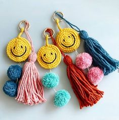 crocheted smiley face keychains with tassels and pom poms