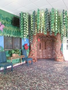 a room decorated with paper flowers and trees