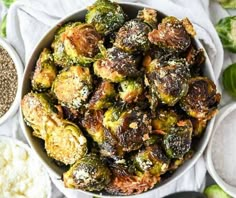 a bowl filled with brussel sprouts next to other vegetables and seasonings