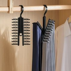 the clothes hangers are hanging on the wooden closet door and there is also a tie rack