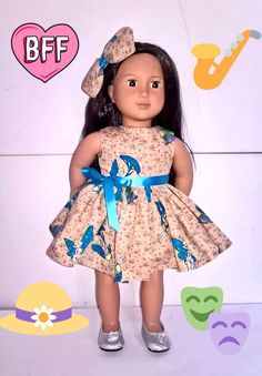 an american girl doll wearing a dress and hat with blue bow on her head, standing in front of a white background