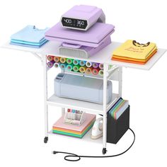 a computer desk with a clock on top of it and various office supplies around it