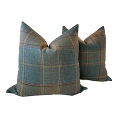 two blue and green plaid pillows on a white background