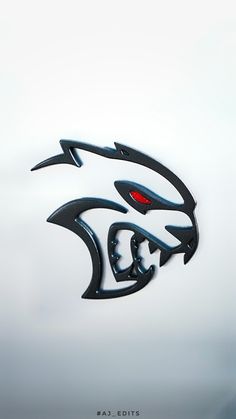 an image of a car emblem on the side of a vehicle that is painted black and red