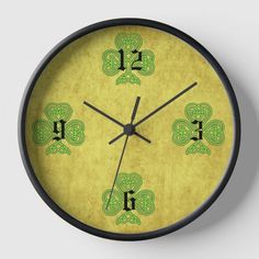 a clock with green numbers and shamrocks on it