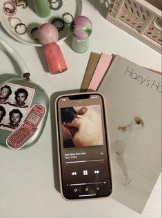 a cell phone sitting on top of a table next to a book and other items