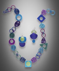 Metal Necklace - A cascade of fun, this anodized aluminum necklace has a lively and appealing combination of peacock colors and geometric shapes. Designed, handcrafted, anodized, and dyed by the artist, this necklace offers an artful design that is sure to become a favorite piece. Adjustable design with hook clasp. Artsy Blue Jewelry For Party, Artsy Blue Metal Jewelry, Modern Blue Metal Necklaces, Modern Blue Metal Necklace, Modern Blue Necklaces For Parties, Modern Blue Necklace For Party, Modern Multicolor Jewelry With Unique Variations, Modern Blue Jewelry With Unique Variations, Modern Multicolor Jewelry With Bold Design