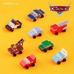 a group of toy cars sitting on top of a yellow surface