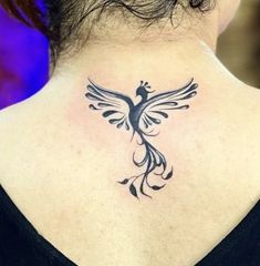 a woman with a tattoo on her back neck