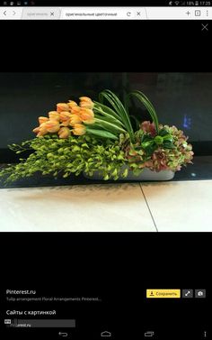 a vase filled with lots of flowers on top of a table