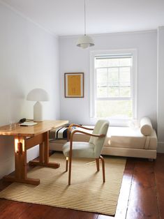 a living room with a couch, table and chair