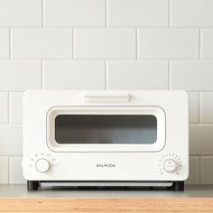 a white microwave oven sitting on top of a counter